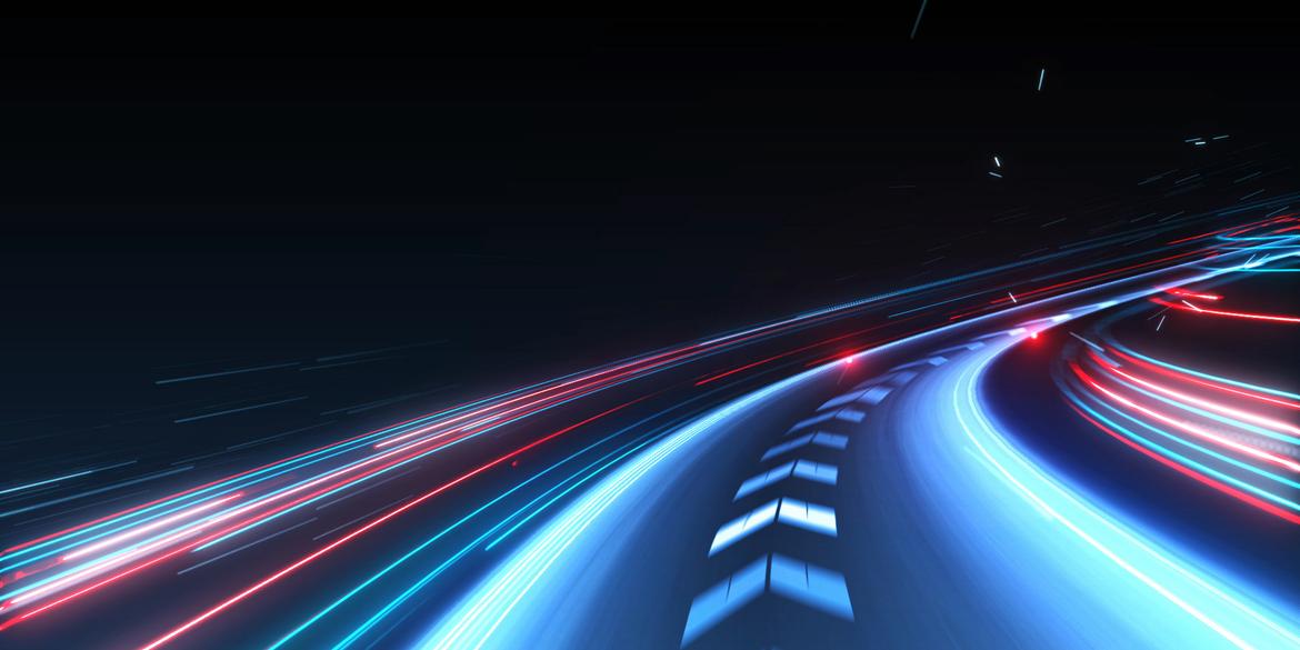 A road at night with lots of abstract lights depicting motion