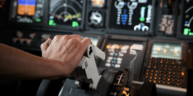 Pilot's hand accelerating on the throttle