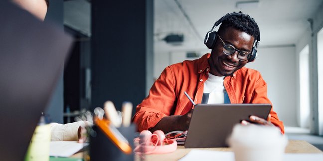 Man smiling using laptop