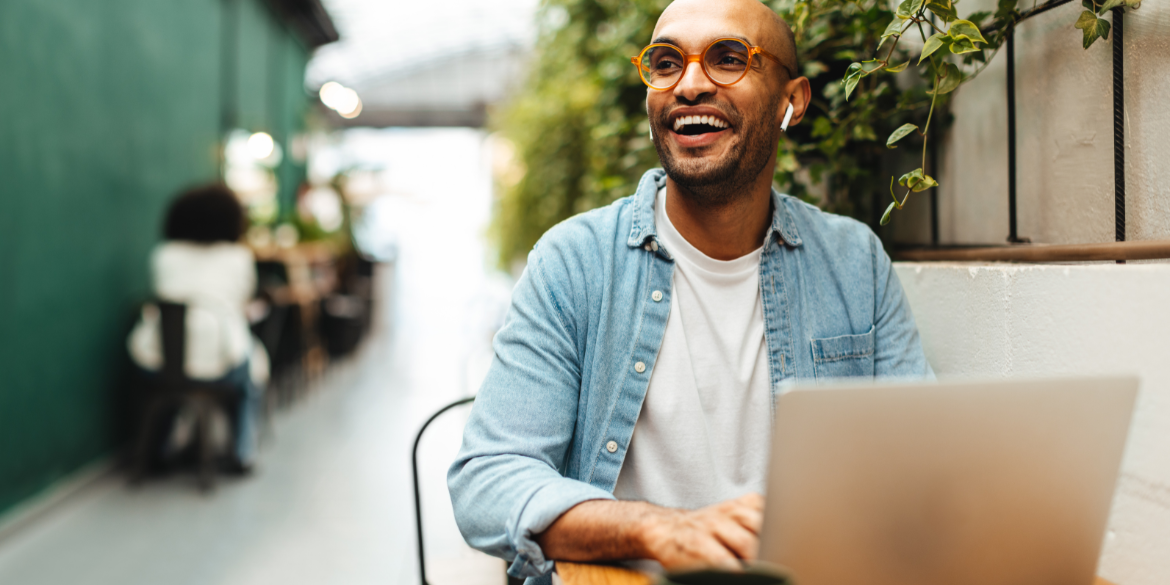 Man outside on laptop.