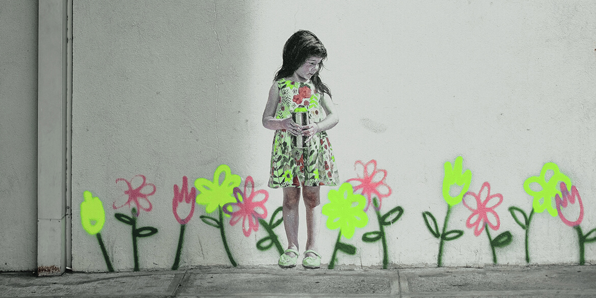 Graffiti on wall of girl among flowers.